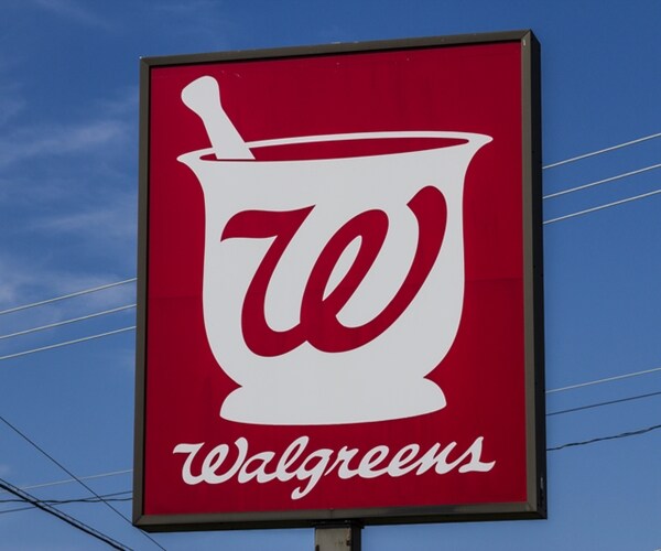 Walgreens Boots Alliance logo depicted by a red logo sign against a blue sky