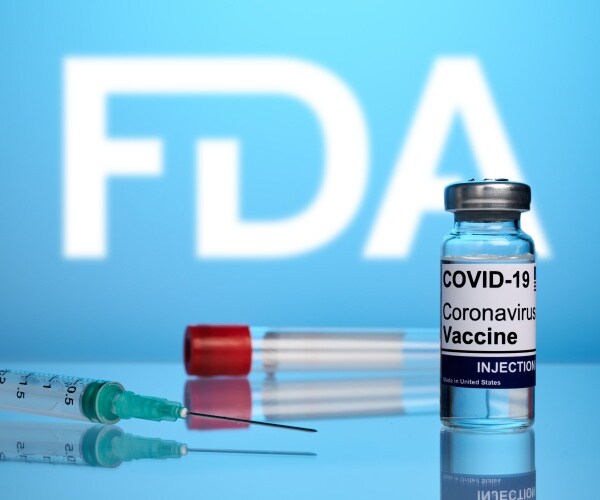 syringes in front of FDA logo