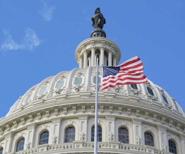 top of us capitol with flag flying