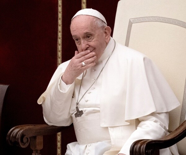 Pope Francis sitting in a chair, addressing an audience