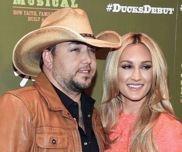 jason aldean and brittany kerr aldean posing for a photo