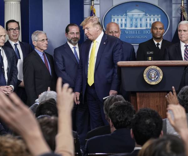 trump and other members of staff on podium