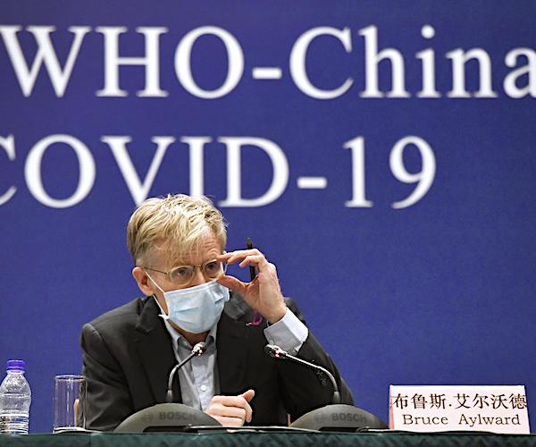 bruce aylward wears a mask during a world health organization news conference