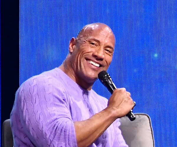 dwayne johnson sits onstage