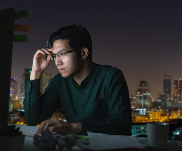 man working at desk late at night