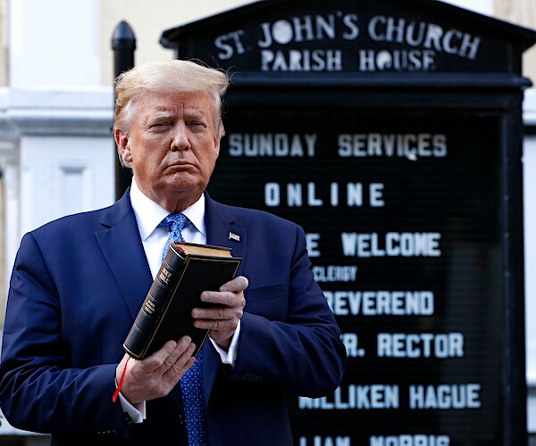 President Donald Trump holds a Bible as he visits outside St. John's Church across Lafayette Park in d.c.