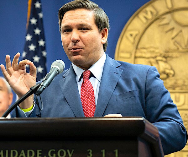 ron desantis gestures and speaks during a news conference