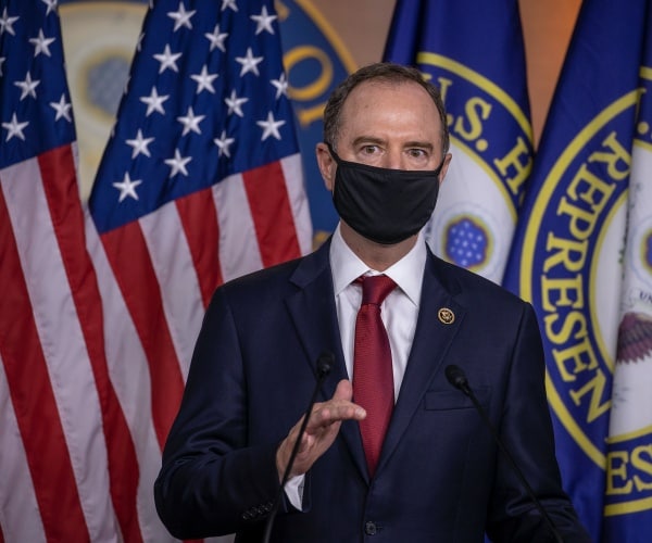 adam schiff wearing a mask walking to the press