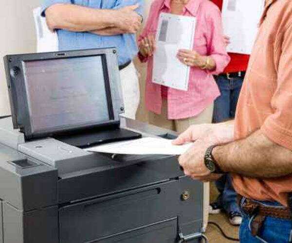 a voter inserts a ballot into a voting machine