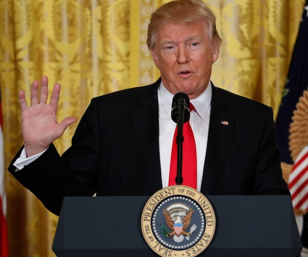 president donald trump gestures with his right hand during a contentious news conference