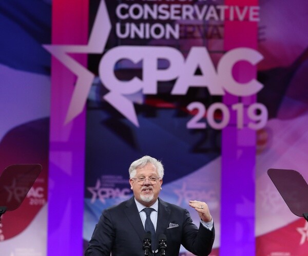 beck in a black suit and navy blue tie speaking at cpac in 2019