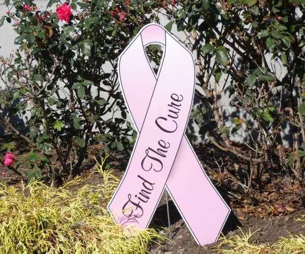 pink ribbon with the message find the cure