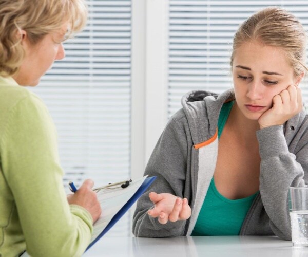 Teenaged girl talking to therapist