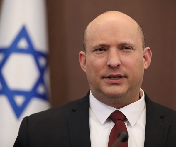 Naftali Bennett looks on