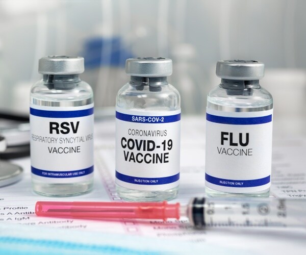 vials with vaccines for RSV, COVID, Flu and a syringe