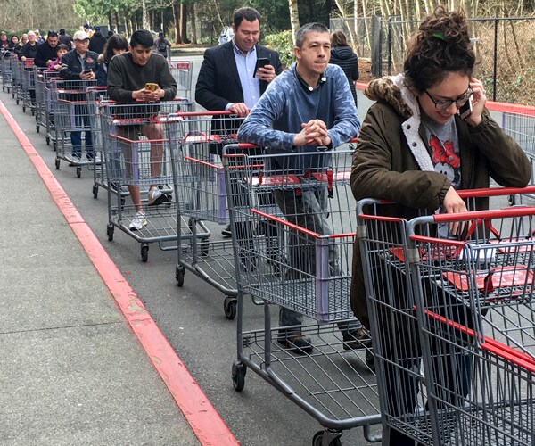 customers wait in line to enter a costco in everett washington