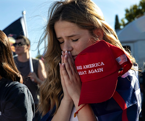 Liza Durasenko, 16, from Oregon City prays during a rally in support of President Donald Trump