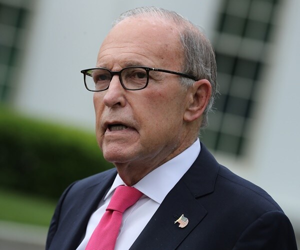 larry kudlow speaks with the white house behind him