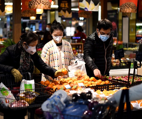 people wearing face masks shop in wuhan, china