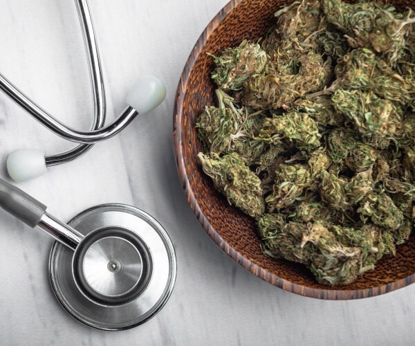 loose marijuana in bowl and a stethoscope