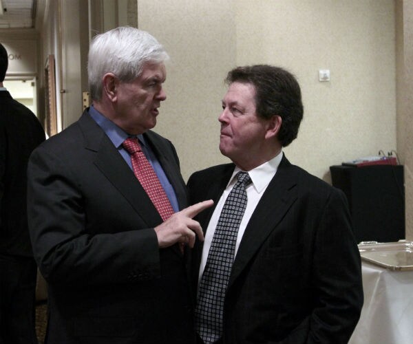 newt gingrich stands very closely with art laffer as the two speak to each other