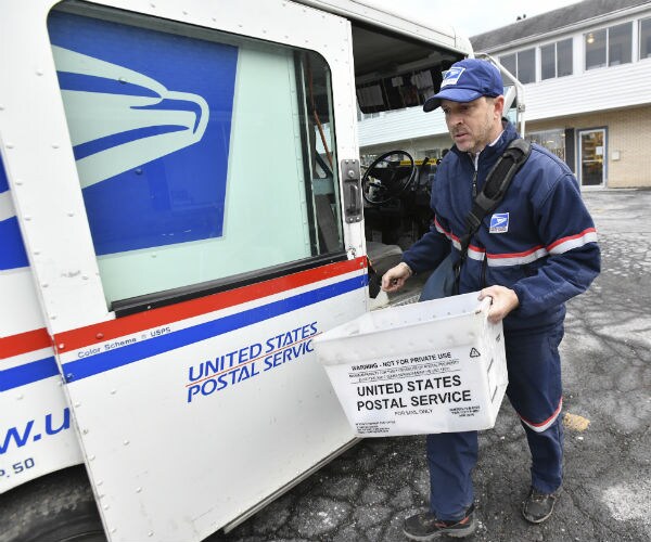 usps carrier chris sweeney carries mail from his usps vehicle