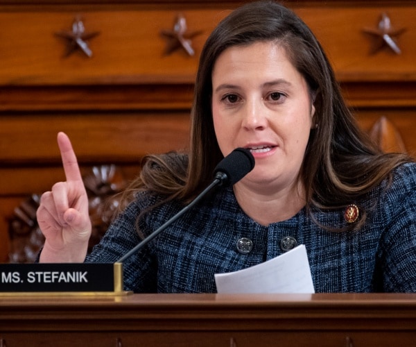 stefanik in a blue plaid coat