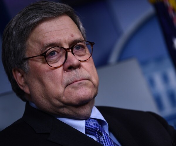 william barr in a suit, blue shirt and dark blue tie in the press briefing room