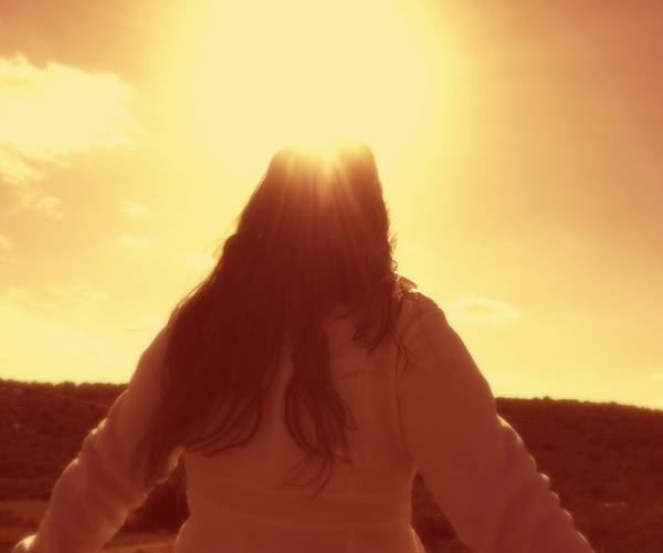 woman looking into the sunlight