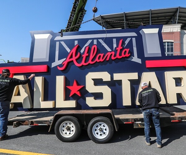 workers load all star sign onto flatbed