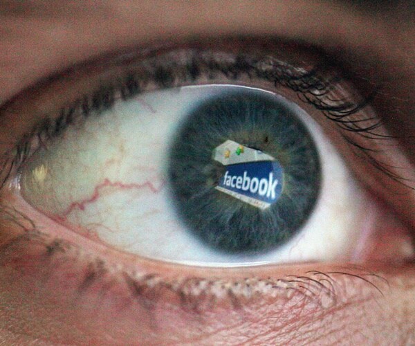 facebook logo is reflected in an eye