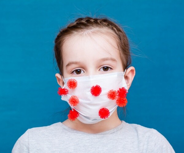 young girl with mask on and red "virus" particles all over mask