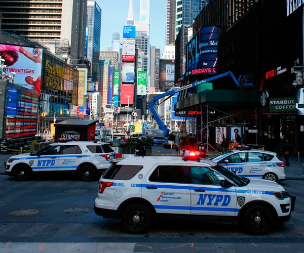 new york city police department cruisers parked in times square