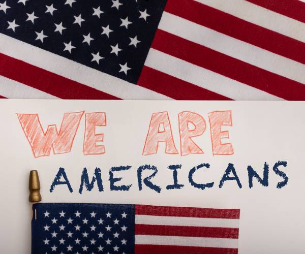 two american flags with the words we are americans