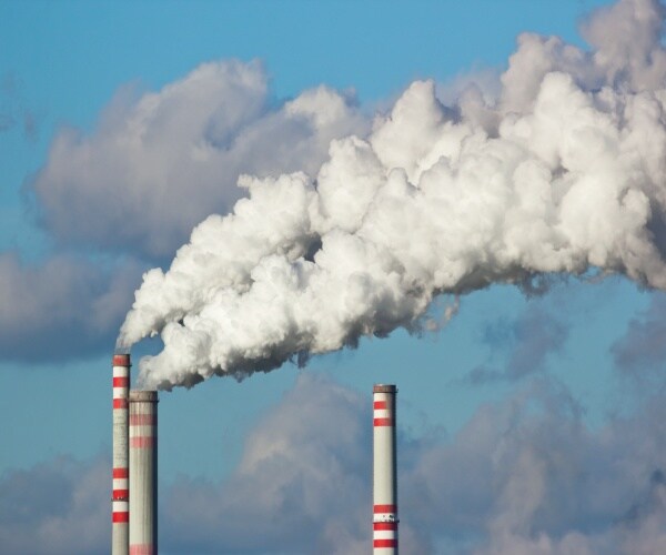 smokestacks with smoke billowing out