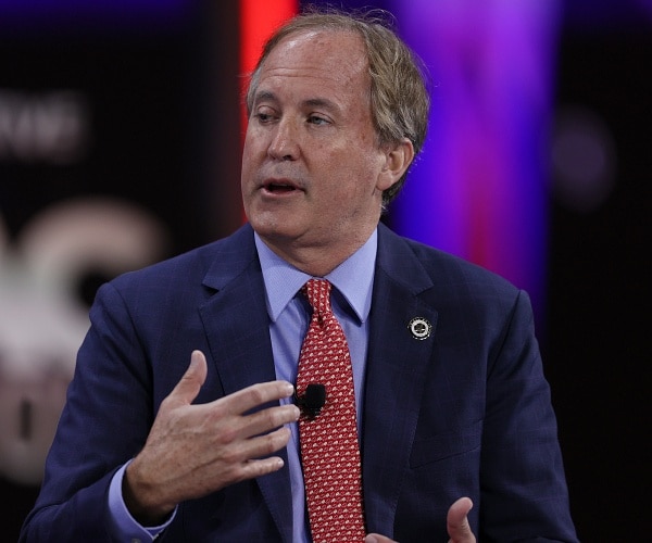 ken paxton speaks onstage at cpac