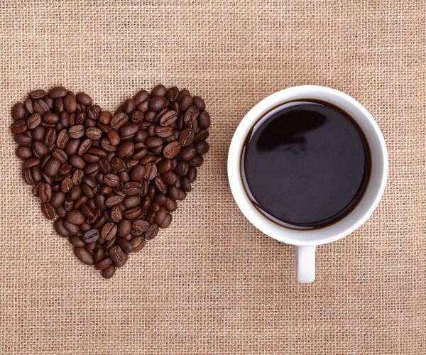 coffee beans in shape of a heart, coffee cup with coffee