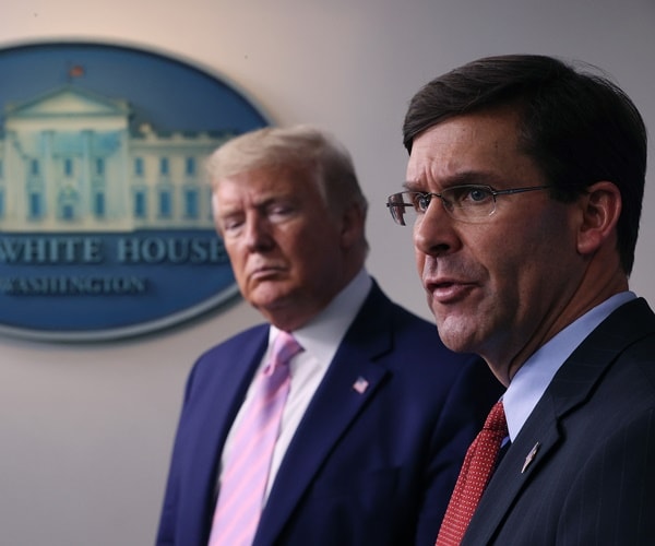 mark esper speaks while president listens