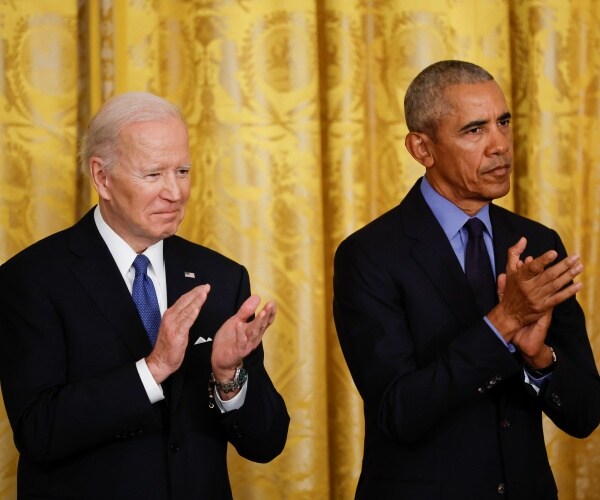 joe biden and barack obama clap their hands