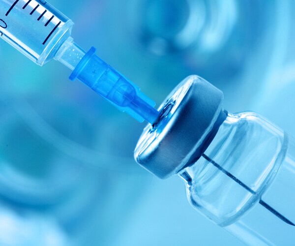 a syringe in a vaccine vial