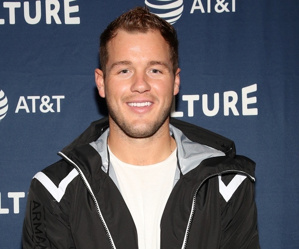 colton underwood stands on red carpet