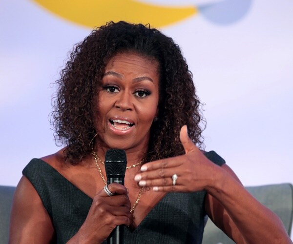 michelle obama speaks to an audience seated on a stage