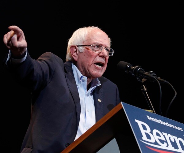 bernie sanders campaigns at a rally