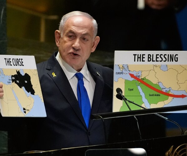 netanyahu holds up two maps reading blessing and curse