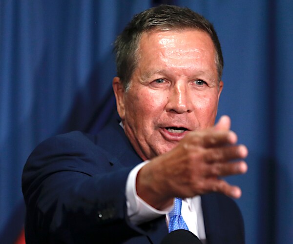 ohio governor john kasich points forward with the four fingers of his right hand