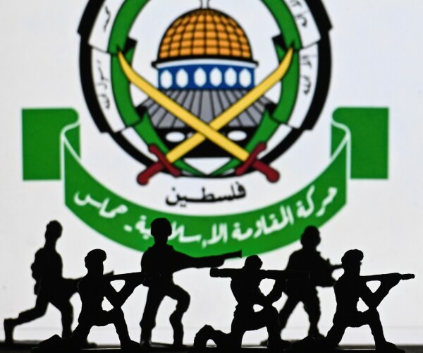 illustration of terrorists in front of the hamas symbol