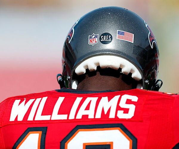 the back of an nfl helmet showing decals honoring america and sandy hook elementary school