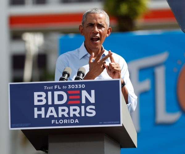 barack obama stands behind podium