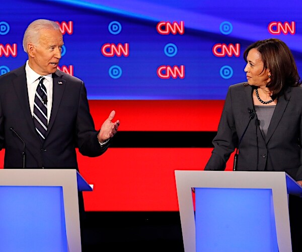 joe biden raises both hands as he is challenged by kamala harris on busing