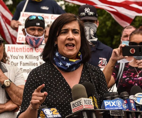 nicole malliotakis speaks into microphones